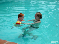 Elliot playing in the pool with his Mom